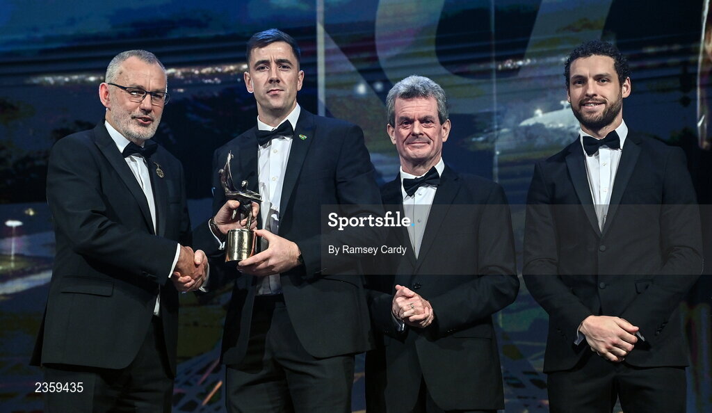 28 October 2022; Diarmaid Byrnes of Limerick is presented with his PwC All-Star award by Uachtarán Chumann Lúthchleas Gael Larry McCarthy, PwC Ireland managing partner Feargal O'Rourke and GPA chief executive officer Tom Parsons during the PwC All-Stars Awards 2022 show at the Convention Centre in Dublin. Photo by Ramsey Cardy/Sportsfile