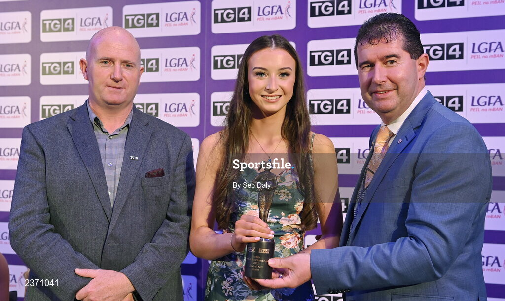 4 November 2022; Sarah O’Neill of Antrim is presented with her TG4 Junior Team of the Championship award by Mícheál Naughton, LGFA President, right, and Rónán Ó Coisdealbha, Head of Sport, TG4, at the 2022 TG4 Teams of the Championship awards night at Croke Park, Dublin. Photo by Seb Daly/Sportsfile