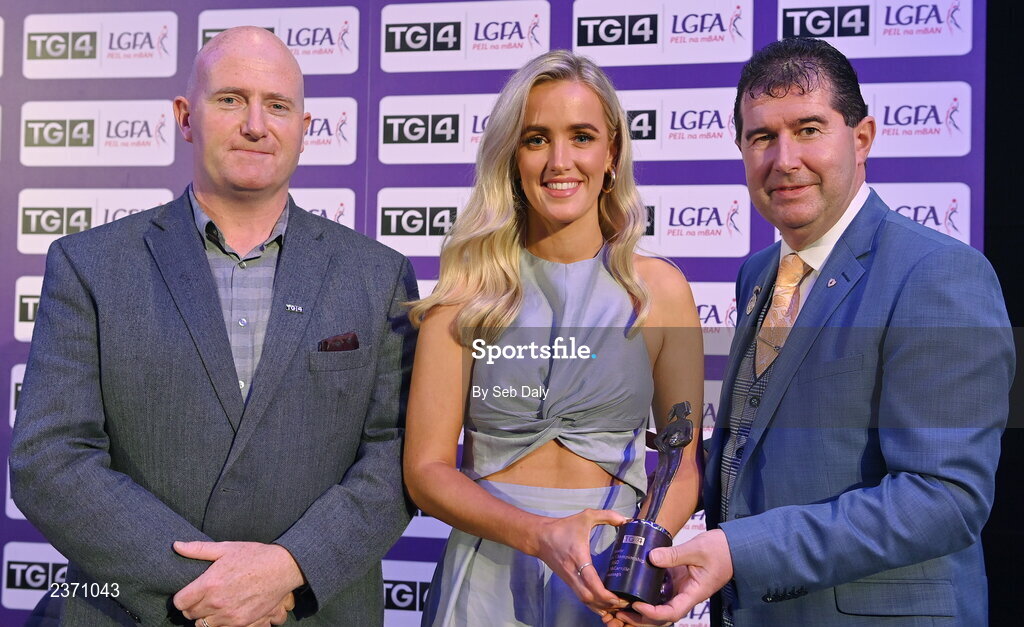 4 November 2022; Sarah McCarville of Fermanagh is presented with her TG4 Junior Team of the Championship award by Mícheál Naughton, LGFA President, right, and Rónán Ó Coisdealbha, Head of Sport, TG4, at the 2022 TG4 Teams of the Championship awards night at Croke Park, Dublin. Photo by Seb Daly/Sportsfile