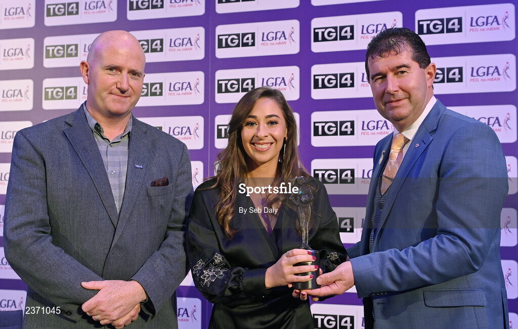 4 November 2022; Kristine Reidy of Limerick is presented with her TG4 Junior Team of the Championship award by Mícheál Naughton, LGFA President, right, and Rónán Ó Coisdealbha, Head of Sport, TG4, at the 2022 TG4 Teams of the Championship awards night at Croke Park, Dublin. Photo by Seb Daly/Sportsfile