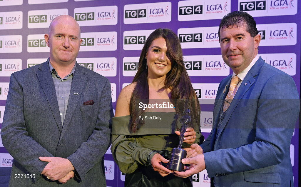 4 November 2022; Aislinn McFarland of Antrim is presented with her TG4 Junior Team of the Championship award by Mícheál Naughton, LGFA President, right, and Rónán Ó Coisdealbha, Head of Sport, TG4, at the 2022 TG4 Teams of the Championship awards night at Croke Park, Dublin. Photo by Seb Daly/Sportsfile