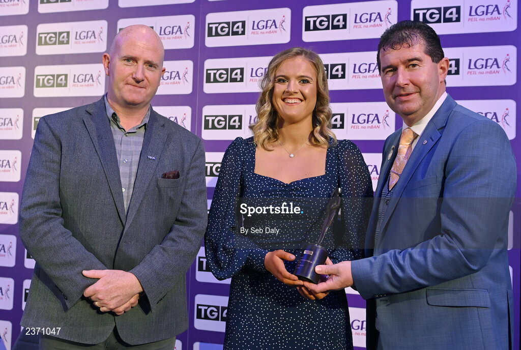 4 November 2022; Anna McCann of Antrim is presented with her TG4 Junior Team of the Championship award by Mícheál Naughton, LGFA President, right, and Rónán Ó Coisdealbha, Head of Sport, TG4, at the 2022 TG4 Teams of the Championship awards night at Croke Park, Dublin. Photo by Seb Daly/Sportsfile