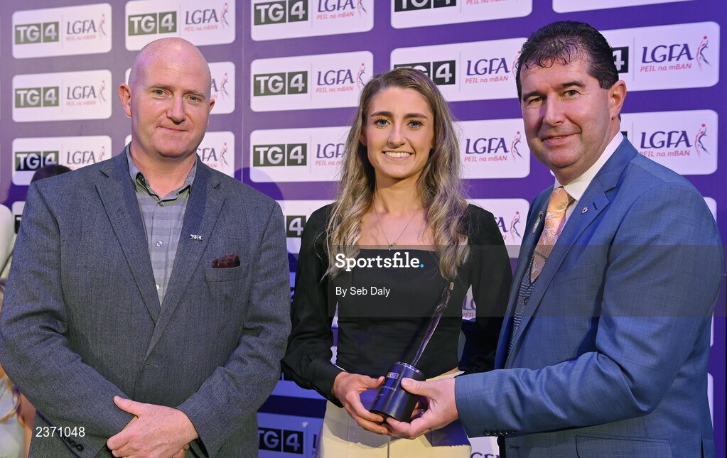 4 November 2022; Orlaith Prenter of Antrim is presented with her TG4 Junior Team of the Championship award by Mícheál Naughton, LGFA President, right, and Rónán Ó Coisdealbha, Head of Sport, TG4, at the 2022 TG4 Teams of the Championship awards night at Croke Park, Dublin. Photo by Seb Daly/Sportsfile
