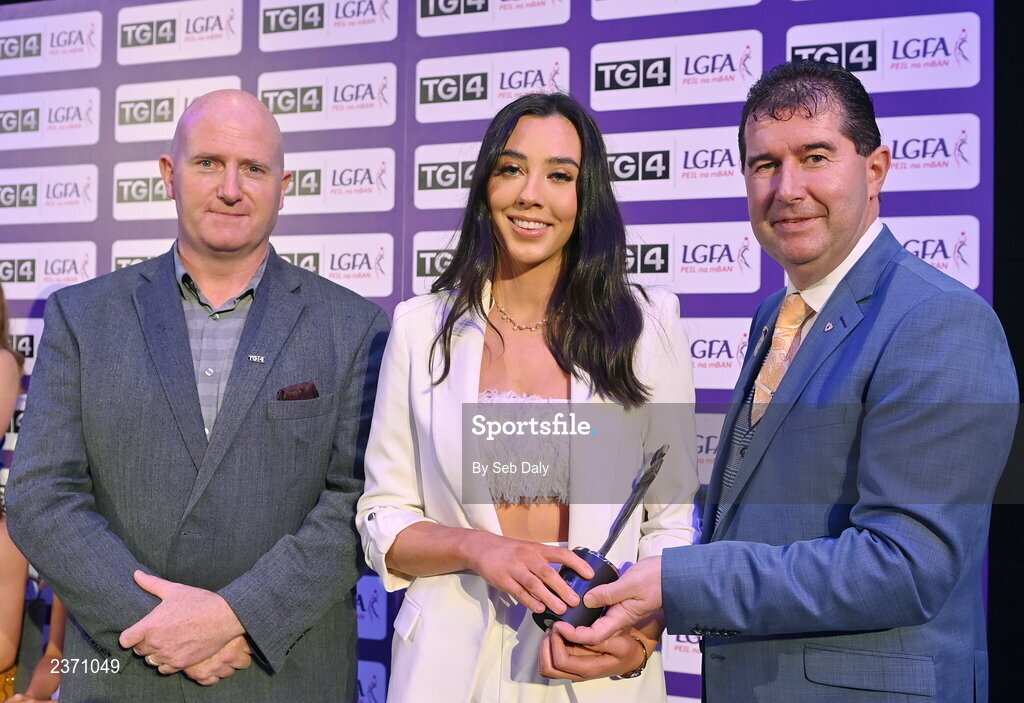 4 November 2022; Bláithín Bogue of Fermanagh is presented with her TG4 Junior Team of the Championship award by Mícheál Naughton, LGFA President, right, and Rónán Ó Coisdealbha, Head of Sport, TG4, at the 2022 TG4 Teams of the Championship awards night at Croke Park, Dublin. Photo by Seb Daly/Sportsfile