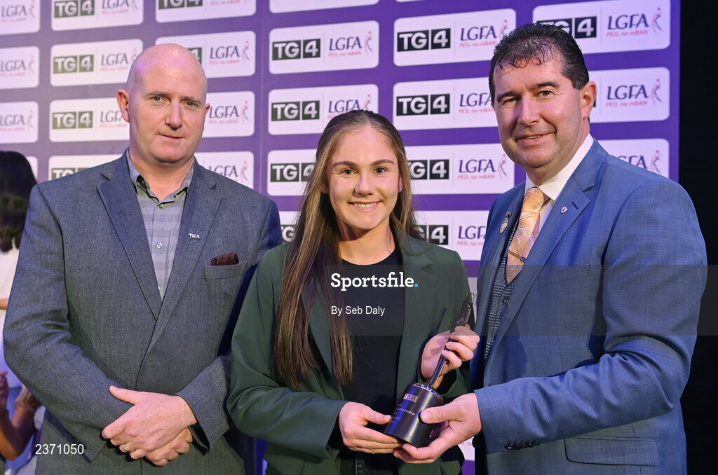 4 November 2022; Rachel Sawyer of Carlow is presented with her TG4 Junior Team of the Championship award by Mícheál Naughton, LGFA President, right, and Rónán Ó Coisdealbha, Head of Sport, TG4, at the 2022 TG4 Teams of the Championship awards night at Croke Park, Dublin. Photo by Seb Daly/Sportsfile