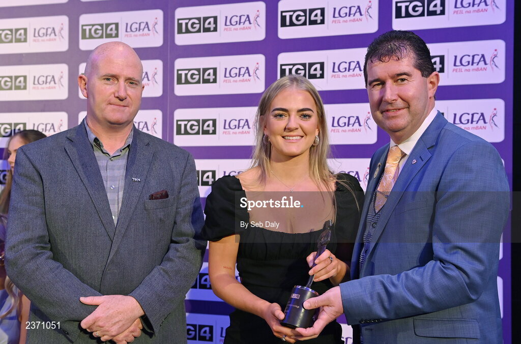 4 November 2022; Sara Doyle of Carlow is presented with her TG4 Junior Team of the Championship award by Mícheál Naughton, LGFA President, right, and Rónán Ó Coisdealbha, Head of Sport, TG4, at the 2022 TG4 Teams of the Championship awards night at Croke Park, Dublin. Photo by Seb Daly/Sportsfile