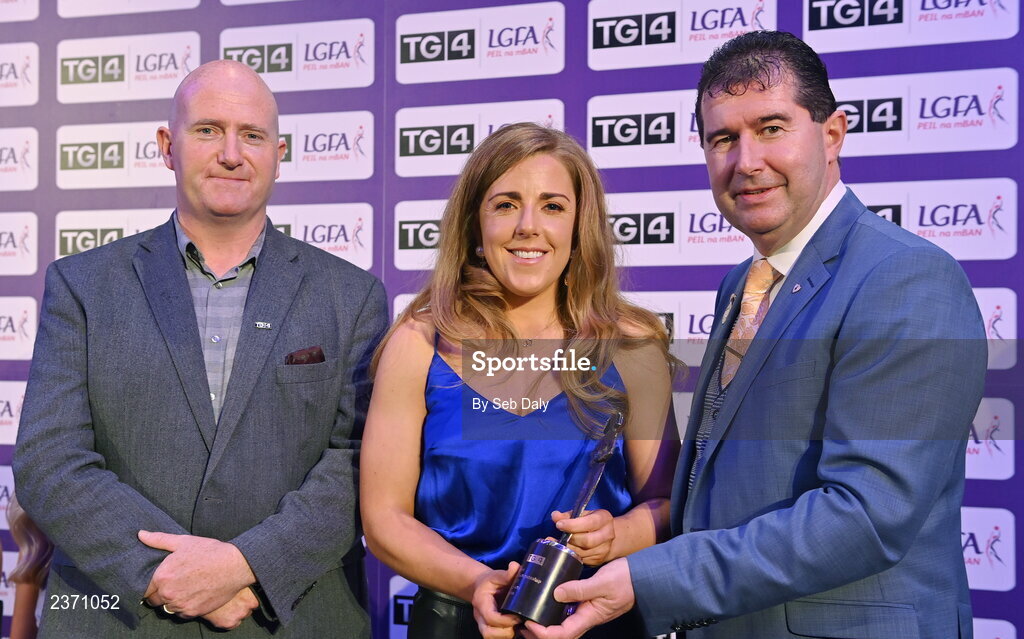 4 November 2022; Cathy Carey of Antrim is presented with her TG4 Junior Team of the Championship award by Mícheál Naughton, LGFA President, right, and Rónán Ó Coisdealbha, Head of Sport, TG4, at the 2022 TG4 Teams of the Championship awards night at Croke Park, Dublin. Photo by Seb Daly/Sportsfile