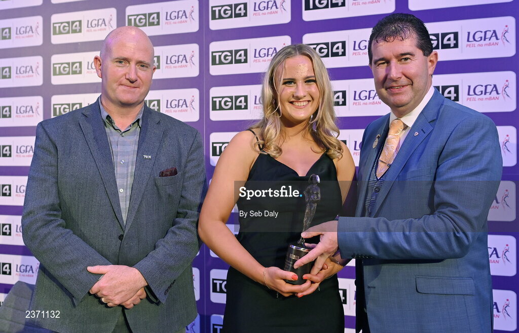 4 November 2022; Tara Kelly of Clare is presented with her TG4 Intermediate Team of the Championship award by Mícheál Naughton, LGFA President, right, and Rónán Ó Coisdealbha, Head of Sport, TG4, at the 2022 TG4 Teams of the Championship awards night at Croke Park, Dublin. Photo by Seb Daly/Sportsfile