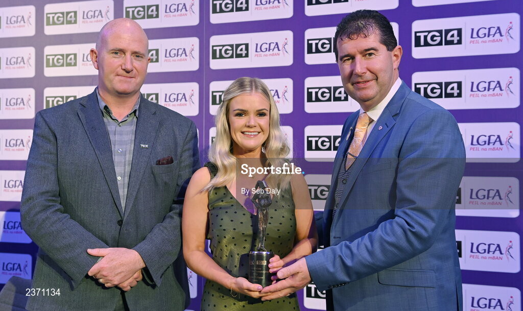 4 November 2022; Rachel Williams of Laois is presented with her TG4 Intermediate Team of the Championship award by Mícheál Naughton, LGFA President, right, and Rónán Ó Coisdealbha, Head of Sport, TG4, at the 2022 TG4 Teams of the Championship awards night at Croke Park, Dublin. Photo by Seb Daly/Sportsfile