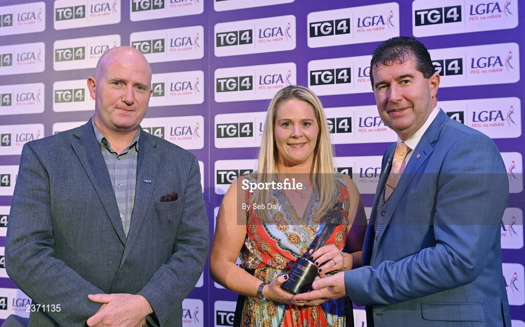 4 November 2022; Eimear Barry of Laois is presented with her TG4 Intermediate Team of the Championship award by Mícheál Naughton, LGFA President, right, and Rónán Ó Coisdealbha, Head of Sport, TG4, at the 2022 TG4 Teams of the Championship awards night at Croke Park, Dublin. Photo by Seb Daly/Sportsfile