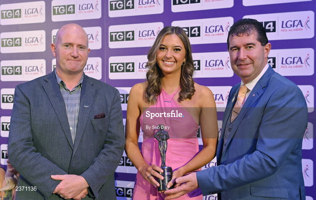 4 November 2022; Aisling Reidy of Clare is presented with her TG4 Intermediate Team of the Championship award by Mícheál Naughton, LGFA President, right, and Rónán Ó Coisdealbha, Head of Sport, TG4, at the 2022 TG4 Teams of the Championship awards night at Croke Park, Dublin. Photo by Seb Daly/Sportsfile