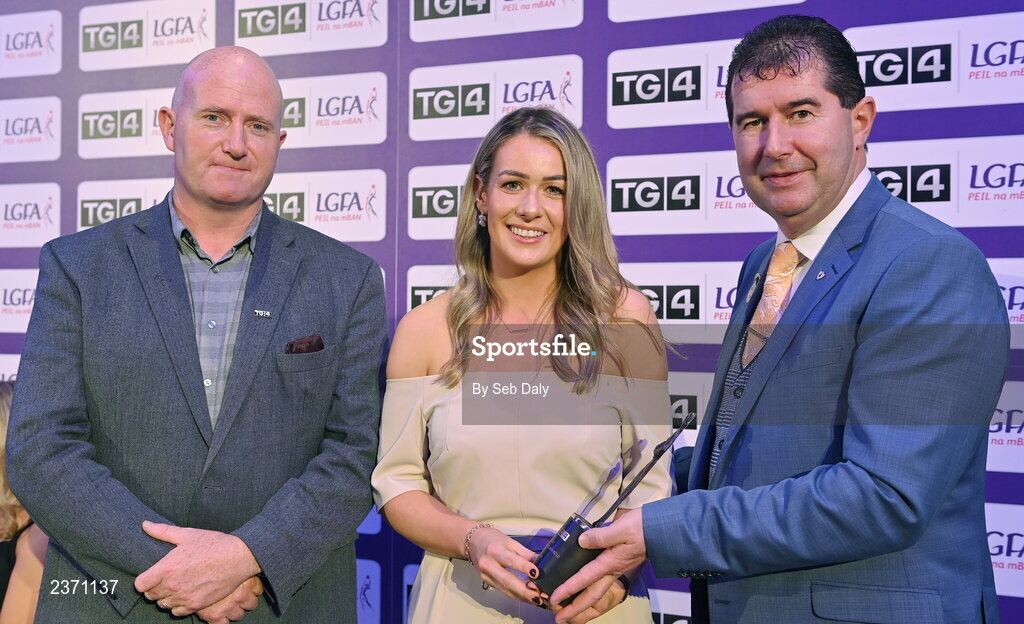 4 November 2022; Ellen Healy of Laois is presented with her TG4 Intermediate Team of the Championship award by Mícheál Naughton, LGFA President, right, and Rónán Ó Coisdealbha, Head of Sport, TG4, at the 2022 TG4 Teams of the Championship awards night at Croke Park, Dublin. Photo by Seb Daly/Sportsfile