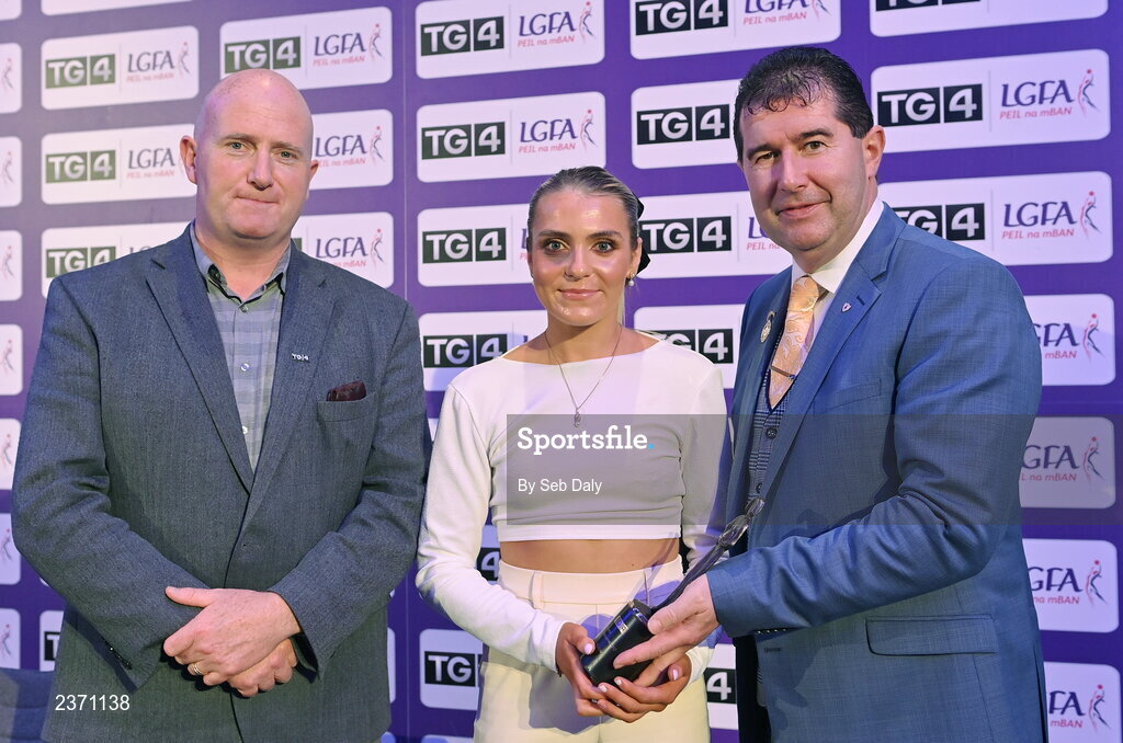 4 November 2022; Sarah Harding Kenny of Wexford is presented with her TG4 Intermediate Team of the Championship award by Mícheál Naughton, LGFA President, right, and Rónán Ó Coisdealbha, Head of Sport, TG4, at the 2022 TG4 Teams of the Championship awards night at Croke Park, Dublin. Photo by Seb Daly/Sportsfile