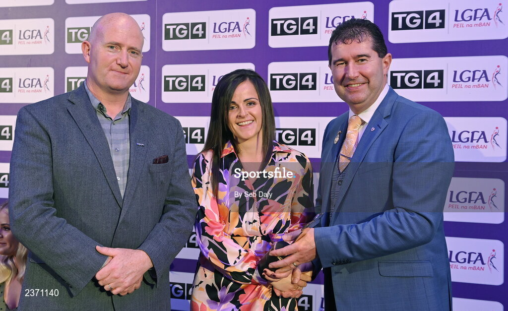 4 November 2022; Caitríona Murray of Wexford is presented with her TG4 Intermediate Team of the Championship award by Mícheál Naughton, LGFA President, right, and Rónán Ó Coisdealbha, Head of Sport, TG4, at the 2022 TG4 Teams of the Championship awards night at Croke Park, Dublin. Photo by Seb Daly/Sportsfile