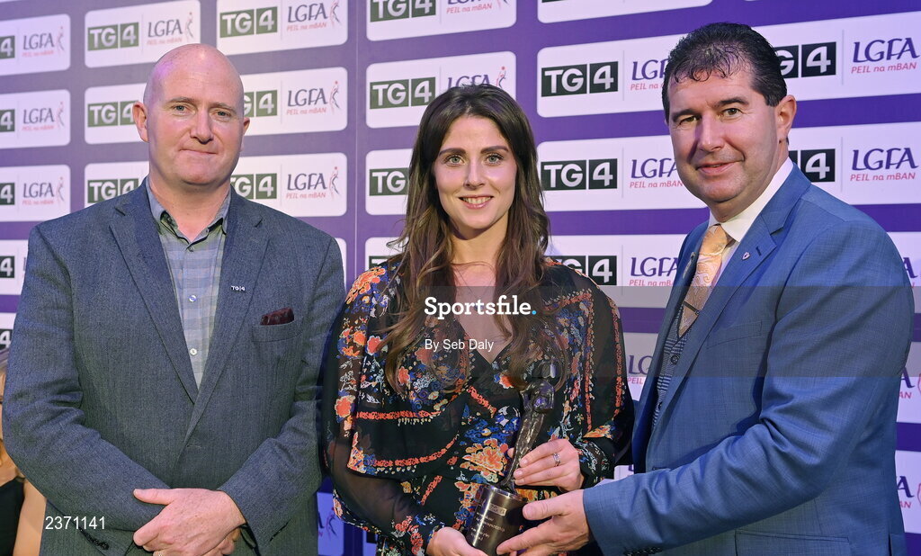 4 November 2022; Róisín Murphy of Wexford is presented with her TG4 Intermediate Team of the Championship award by Mícheál Naughton, LGFA President, right, and Rónán Ó Coisdealbha, Head of Sport, TG4, at the 2022 TG4 Teams of the Championship awards night at Croke Park, Dublin. Photo by Seb Daly/Sportsfile