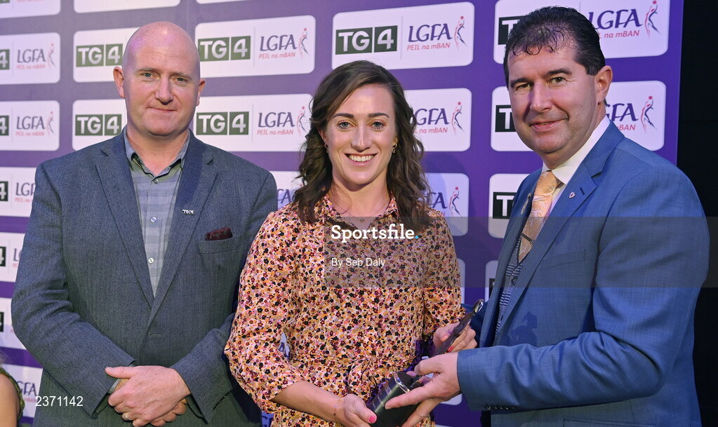 4 November 2022; Laura-Marie Maher of Laois is presented with her TG4 Intermediate Team of the Championship award by Mícheál Naughton, LGFA President, right, and Rónán Ó Coisdealbha, Head of Sport, TG4, at the 2022 TG4 Teams of the Championship awards night at Croke Park, Dublin. Photo by Seb Daly/Sportsfile