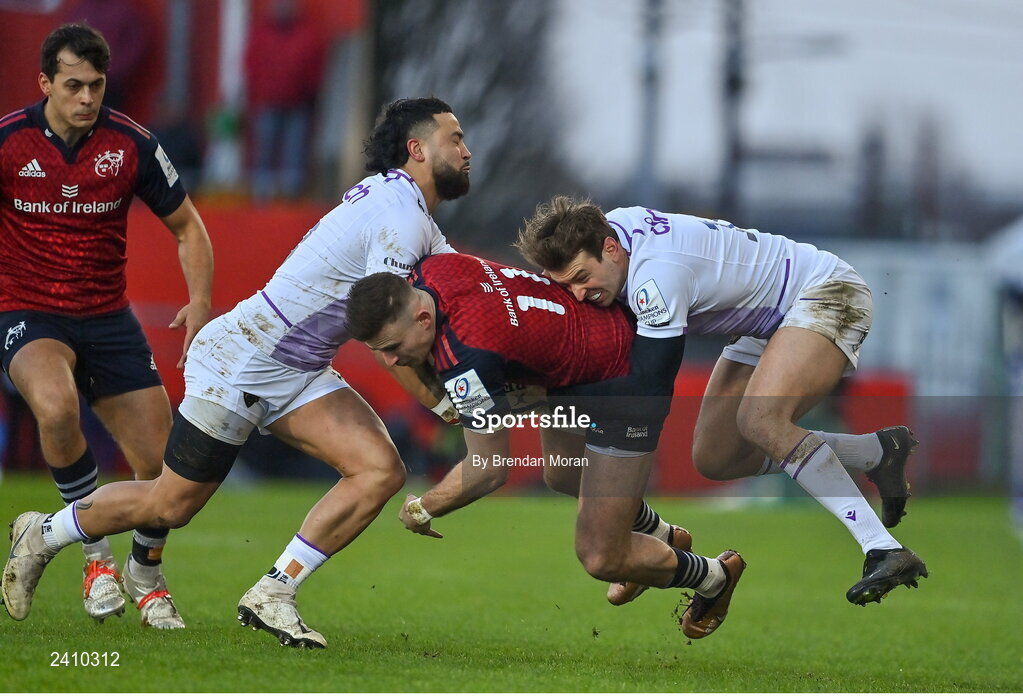 14 January 2023; Shane Daly of Munster is tackled by Lewis Ludlam, left, and James Ramm of Northampton Saints during the Heineken Champions Cup Pool B Round 3 match between Munster and Northampton Saints at Thomond Park in Limerick. Photo by Brendan Moran/Sportsfile