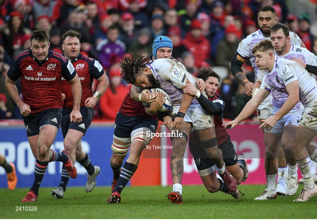 14 January 2023; Lewis Ludlam of Northampton Saints is tackled by Tadhg Beirne of Munster, left, and Joey Carbery of Munster during the Heineken Champions Cup Pool B Round 3 match between Munster and Northampton Saints at Thomond Park in Limerick. Photo by Tyler Miller/Sportsfile