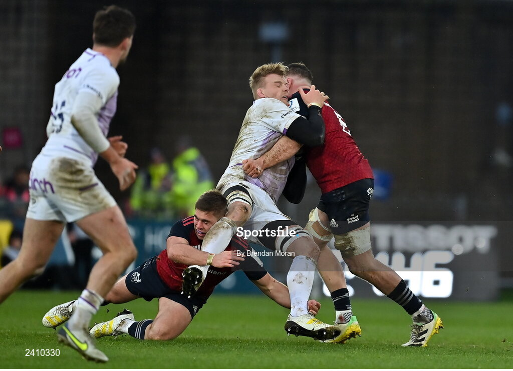 14 January 2023; David Ribbans of Northampton Saints is tackled by Jack Crowley, left, and Jack O’Donoghue of Munster, a tackle for which Jack O’Donoghue was shown a red card, during the Heineken Champions Cup Pool B Round 3 match between Munster and Northampton Saints at Thomond Park in Limerick. Photo by Brendan Moran/Sportsfile