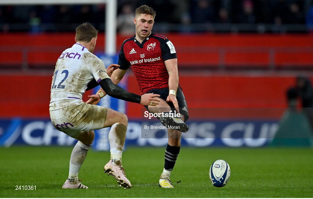 14 January 2023; Jack Crowley of Munster kicks the ball past Rory Hutchinson of Northampton Saints during the Heineken Champions Cup Pool B Round 3 match between Munster and Northampton Saints at Thomond Park in Limerick. Photo by Brendan Moran/Sportsfile