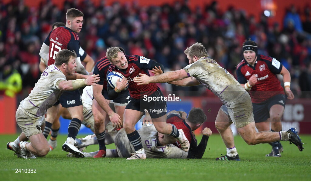 14 January 2023; Craig Casey of Munster is tackled by Paul Hill, left, and Mike Haywood of Northampton Saints during the Heineken Champions Cup Pool B Round 3 match between Munster and Northampton Saints at Thomond Park in Limerick. Photo by Tyler Miller/Sportsfile