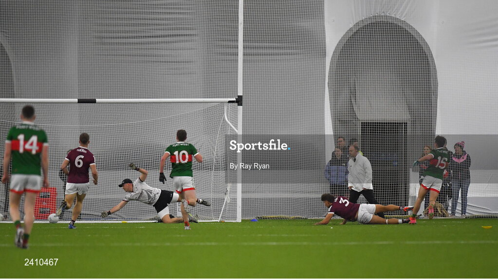 14 January 2023; Paul Towey of Mayo scores his side's first goal past Galway goalkeeper Bernie Power during the Connacht FBD League Semi-Final match between Mayo and Galway at NUI Galway Connacht GAA Air Dome in Bekan, Mayo. Photo by Ray Ryan/Sportsfile