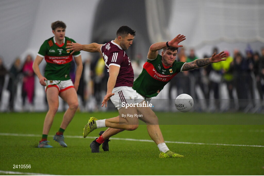 14 January 2023; Damien Comer of Galway in action against Jordan Flynn of Mayo during the Connacht FBD League Semi-Final match between Mayo and Galway at NUI Galway Connacht GAA Air Dome in Bekan, Mayo. Photo by Ray Ryan/Sportsfile