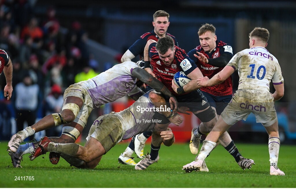 14 January 2023; Peter O’Mahony of Munster is tackled by Courtney Lawes, top, and Paul Hill of Northampton Saints during the Heineken Champions Cup Pool B Round 3 match between Munster and Northampton Saints at Thomond Park in Limerick. Photo by Tyler Miller/Sportsfile