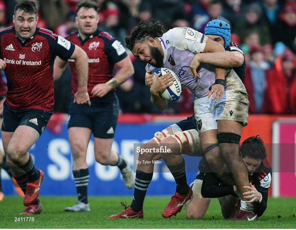 14 January 2023; Lewis Ludlam of Northampton Saints is tackled by Tadhg Beirne of Munster, centre, and Joey Carbery of Munster during the Heineken Champions Cup Pool B Round 3 match between Munster and Northampton Saints at Thomond Park in Limerick. Photo by Tyler Miller/Sportsfile