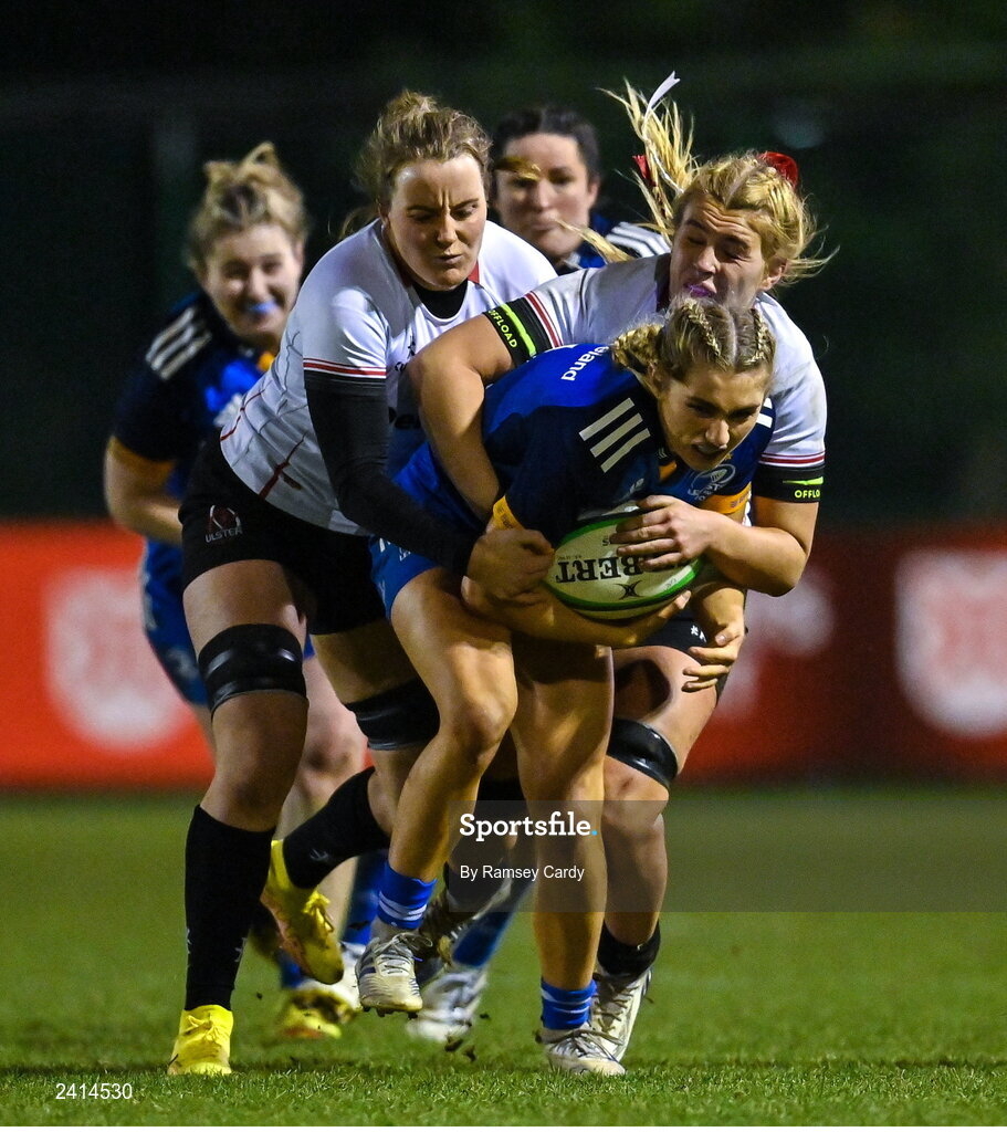 21 January 2023; Anna Doyle of Leinster is tackled by Fern Wilson, left, and India Daley of Ulster during the Vodafone Women’s Interprovincial Championship Round Three match between Ulster and Leinster at Queen’s Sport in Belfast. Photo by Ramsey Cardy/Sportsfile