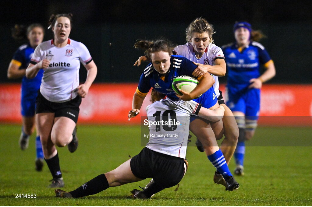 21 January 2023; Lisa Mullen of Leinster is tackled by Ella Durkan, left, and Rachael McIlroy of Ulster during the Vodafone Women’s Interprovincial Championship Round Three match between Ulster and Leinster at Queen’s Sport in Belfast. Photo by Ramsey Cardy/Sportsfile