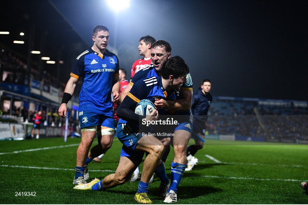 28 January 2023; Max O'Reilly of Leinster celebrates with teammates Liam Turner, right, and Scott Penny, left, after scoring their side's fifth try during the United Rugby Championship match between Leinster and Cardiff at RDS Arena in Dublin. Photo by Ben McShane/Sportsfile
