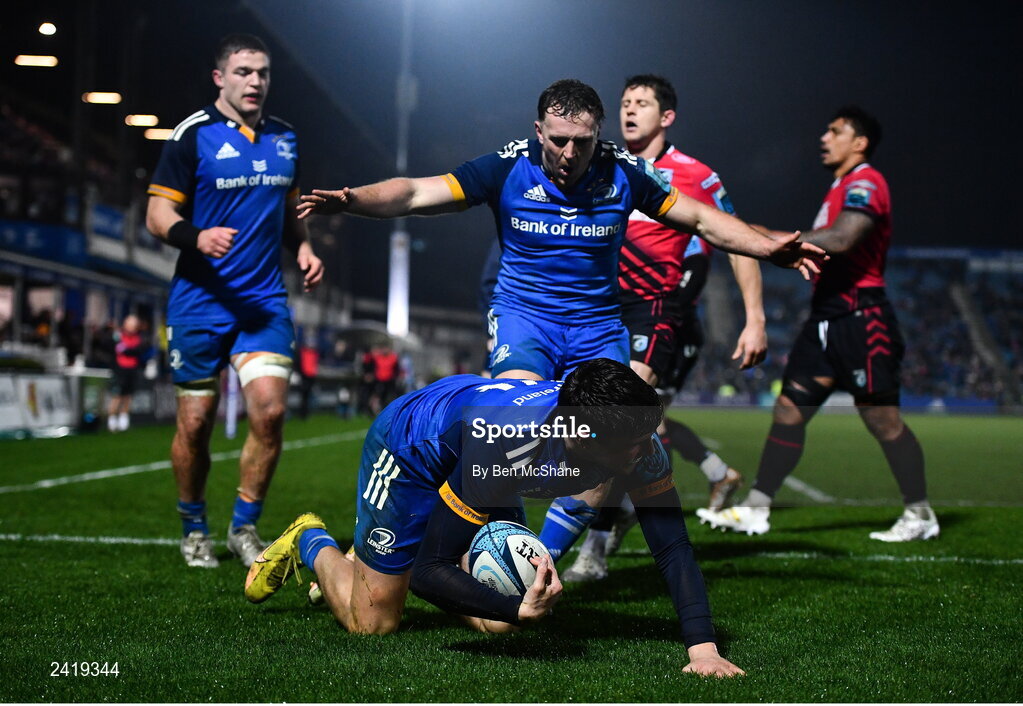 28 January 2023; Max O'Reilly of Leinster celebrates with teammates Liam Turner, right, and Scott Penny, left, after scoring their side's fifth try during the United Rugby Championship match between Leinster and Cardiff at RDS Arena in Dublin. Photo by Ben McShane/Sportsfile