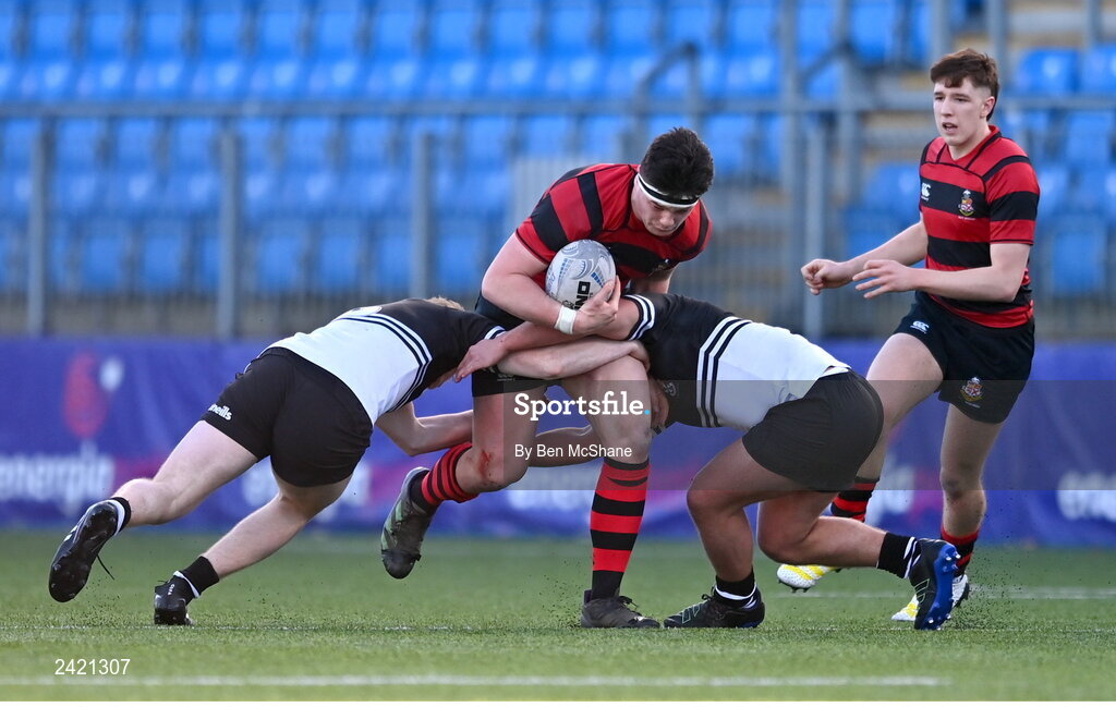31 January 2023; Patrick Bramley of Kilkenny College is tackled by John Sheedy, left, and Mark Masterson of Newbridge College during the Bank of Ireland Leinster Rugby Schools Senior Cup First Round match between Newbridge College and Kilkenny College at Energia Park in Dublin. Photo by Ben McShane/Sportsfile