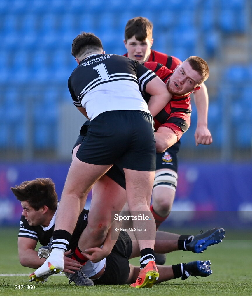 31 January 2023; Adam Watchorn of Kilkenny College is tackled by John Walsh, 1, and Mark Masterson of Newbridge College during the Bank of Ireland Leinster Rugby Schools Senior Cup First Round match between Newbridge College and Kilkenny College at Energia Park in Dublin. Photo by Ben McShane/Sportsfile