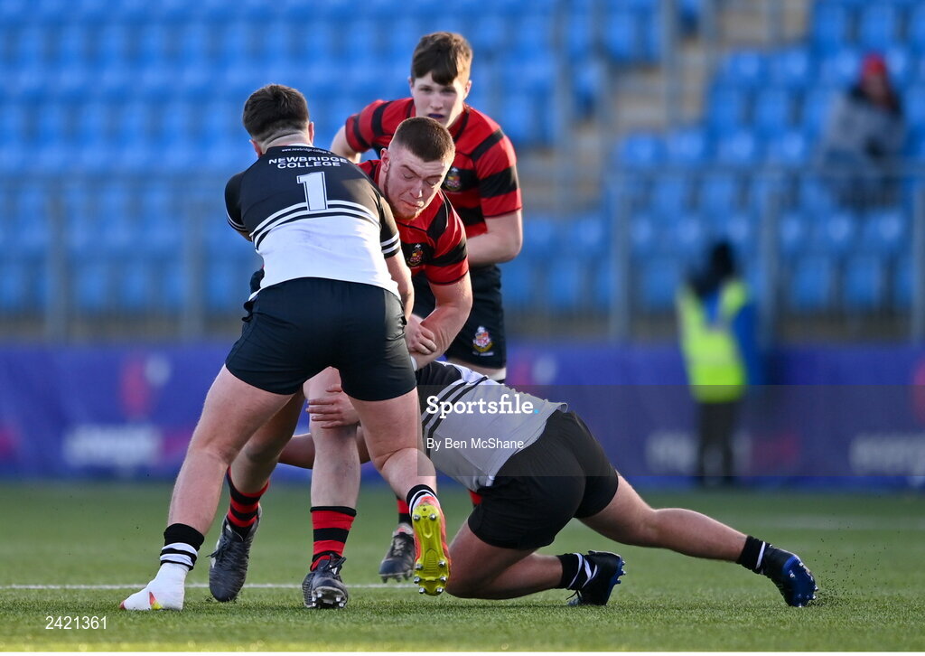 31 January 2023; Adam Watchorn of Kilkenny College is tackled by John Walsh, 1, and Mark Masterson of Newbridge College during the Bank of Ireland Leinster Rugby Schools Senior Cup First Round match between Newbridge College and Kilkenny College at Energia Park in Dublin. Photo by Ben McShane/Sportsfile