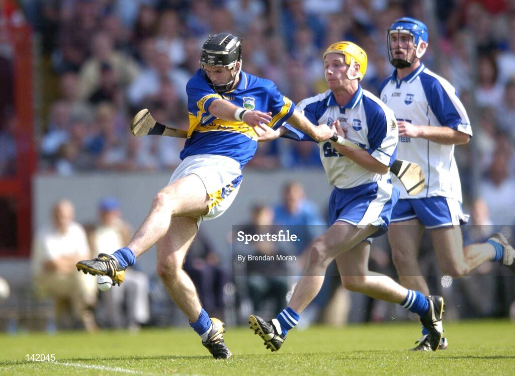 6 June 2004; Colin Morrissey, Tipperary, kicks his sides third goal despite the attentions of Waterford's Eoin Murphy and Declan Prendergast, right. Guinness Munster Senior Hurling Championship semi-final, Tipperary v Waterford, Pairc Ui Chaoimh, Cork. Picture credit; Brendan Moran / SPORTSFILE