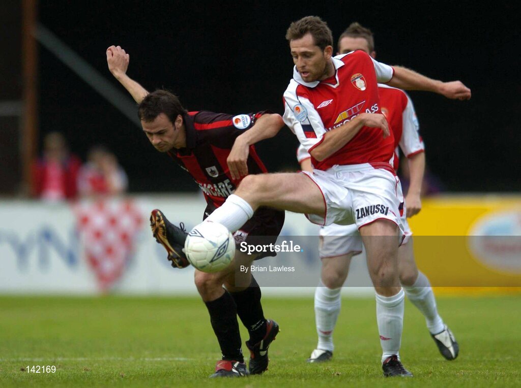 8 June 2004; Des Byrne, St. Patrick's Athletic, in action against John Martin, Longford Town. eircom League, Premier Division, Richmond Park, Dublin. Picture credit; Brian Lawless / SPORTSFILE