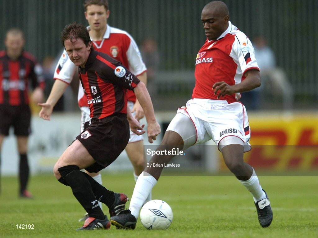 8 June 2004; Joseph Ndo, St. Patrick's Athletic, in action against Dessie Baker, Longford Town. eircom League, Premier Division, Richmond Park, Dublin. Picture credit; Brian Lawless / SPORTSFILE