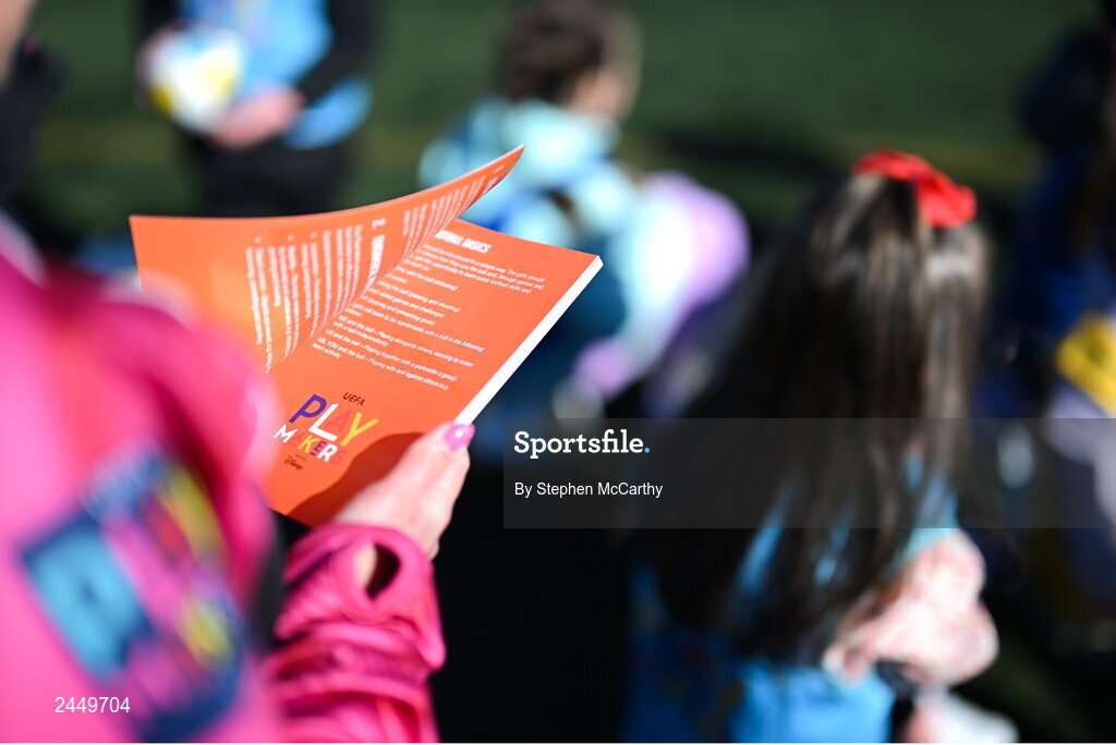 7 March 2023; A coach reads the Playmakers book during the launch of UEFA Disney Playmakers 2023 at Hartstown Huntstown Football Club in Dublin. Photo by Stephen McCarthy/Sportsfile