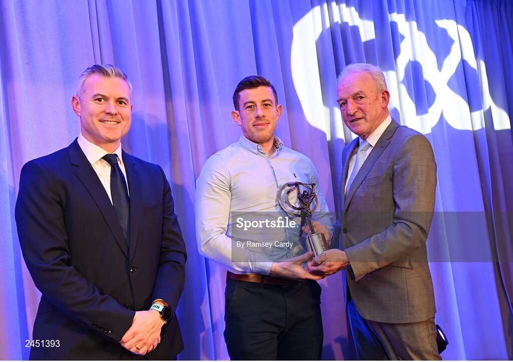 10 March 2023; Kevin Molloy of Dunloy Cúchullain's is presented with his AIB GAA Hurling Club Team of The Year award by GAA Vice President John Murphy and AIB CMO Mark Doyle, at the AIB Club Players Awards at Croke Park in Dublin. Photo by Ramsey Cardy/Sportsfile