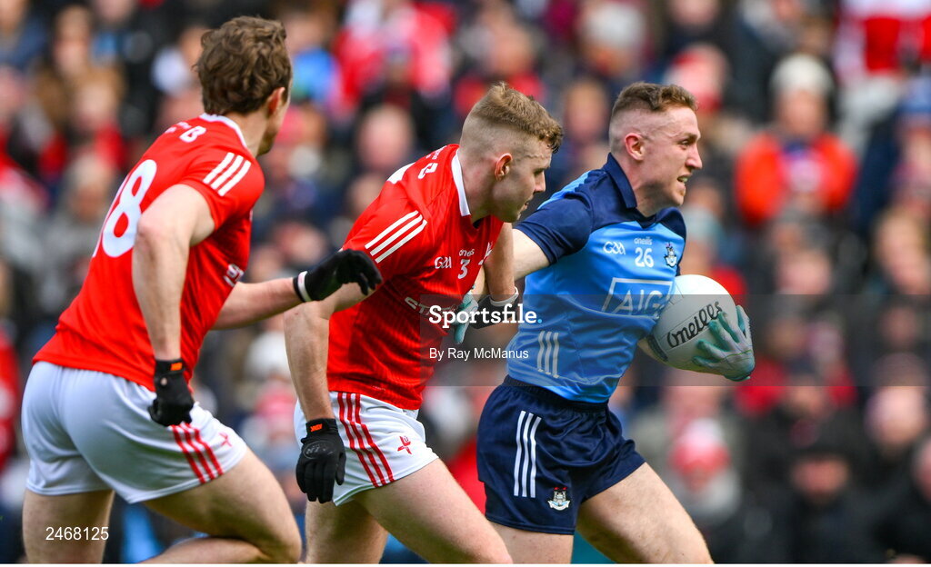 26 March 2023; Paddy Small of Dublin in action against Peter Lynch, 3, and Bevan Duffy of Louth during the Allianz Football League Division 2 match between Dublin and Louth at Croke Park in Dublin. Photo by Ray McManus/Sportsfile