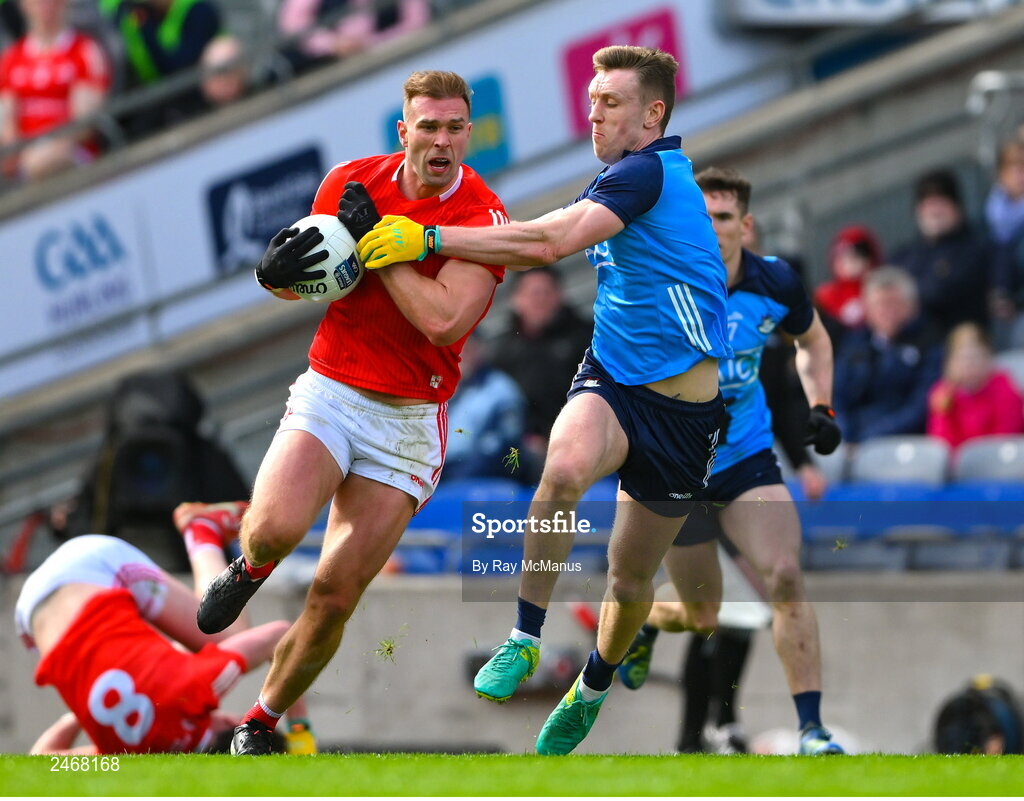 26 March 2023; Conor Grimes of Louth is tackled by Tom Lahiff of Dublin during the Allianz Football League Division 2 match between Dublin and Louth at Croke Park in Dublin. Photo by Ray McManus/Sportsfile