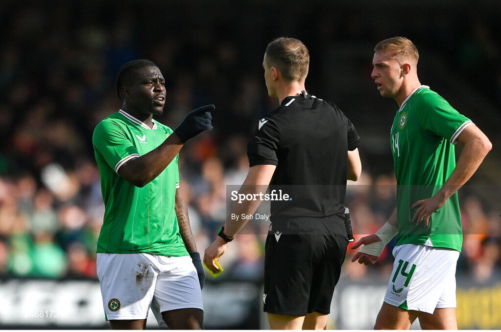 26 March 2023; Festy Ebosele of Republic of Ireland, left, remonstrates with referee Jamie Robinson after being shown a red card during the Under-21 international friendly match between Republic of Ireland and Iceland at Turners Cross in Cork. Photo by Seb Daly/Sportsfile