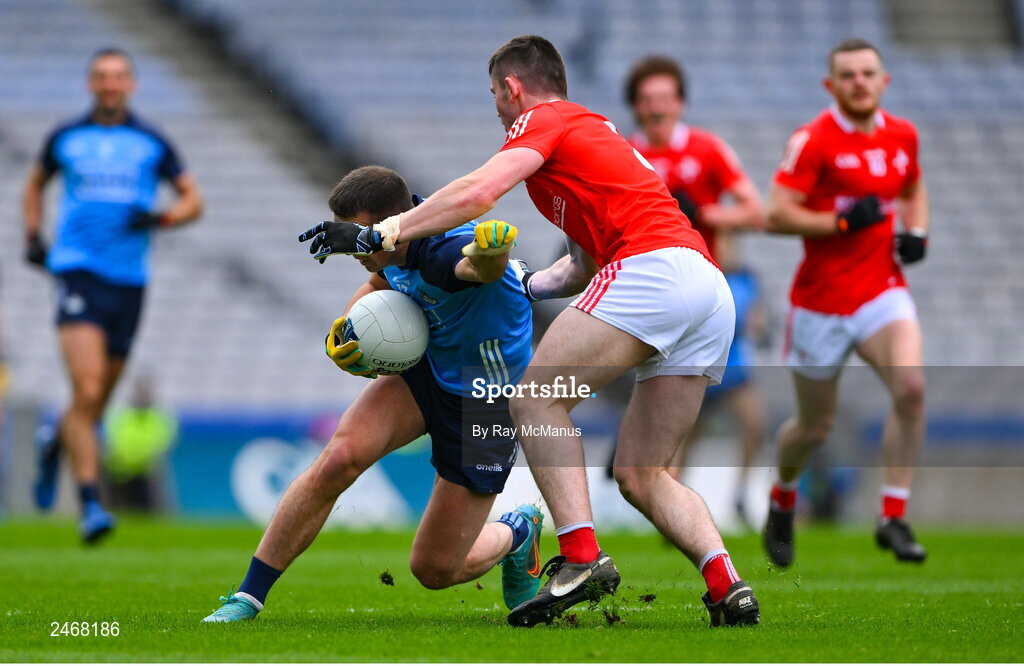26 March 2023; Cormac Costello of Dublin is tackled by Dan Corcoran of Louth during the Allianz Football League Division 2 match between Dublin and Louth at Croke Park in Dublin. Photo by Ray McManus/Sportsfile