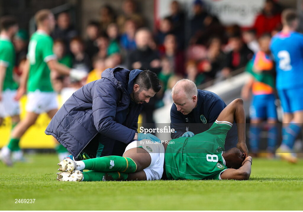 26 March 2023; Bosun Lawal of Republic of Ireland receives medical attention from Republic of Ireland team doctor Dr Mortimer O'Connor, right, and physiotherapist Glauber Barduzzi during the Under-21 international friendly match between Republic of Ireland and Iceland at Turner's Cross in Cork. Photo by Michael P Ryan/Sportsfile