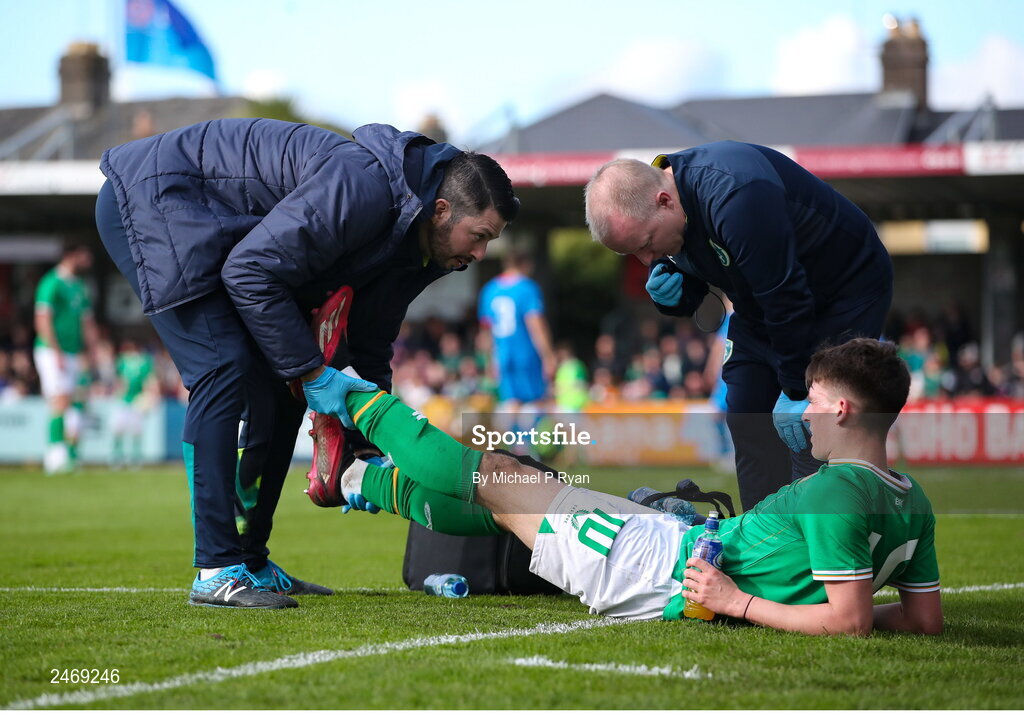 26 March 2023; Andrew Moran of Republic of Ireland receives medical attention from Republic of Ireland team doctor Dr Mortimer O'Connor, right, and physiotherapist Glauber Barduzzi  during the Under-21 international friendly match between Republic of Ireland and Iceland at Turner's Cross in Cork. Photo by Michael P Ryan/Sportsfile