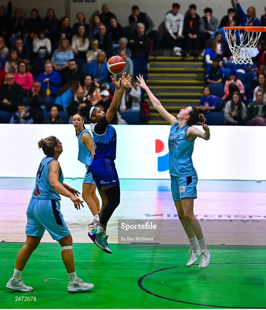 1 April 2023; Khiarica Rasheed of The Address UCC Glanmire scores a basket despite Rachel Huijsdens of DCU Mercy, right, during the MissQuote.ie Champions Trophy Final match between The Address UCC Glanmire, Cork and DCU Mercy, Dublin at National Basketball Arena in Tallaght, Dublin. Photo by Ben McShane/Sportsfile