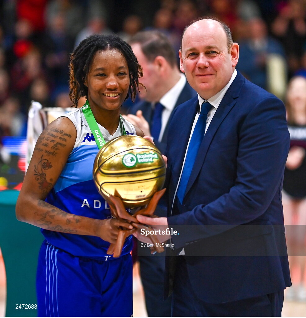 1 April 2023; Brittany Byrd of The Address UCC Glanmire is presented the MVP award by Basketball Ireland president PJ Reidy after the MissQuote.ie Champions Trophy Final match between The Address UCC Glanmire, Cork and DCU Mercy, Dublin at National Basketball Arena in Tallaght, Dublin. Photo by Ben McShane/Sportsfile