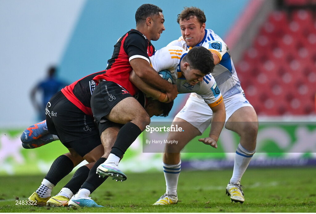 15 April 2023; Ben Brownlee of Leinster, supported by teammate Liam Turner, is tackled by Stean Pienaar and Manuel Rass of Emirates Lions during the United Rugby Championship match between Emirates Lions and Leinster at Emirates Airlines Park in Johannesburg, South Africa. Photo by Harry Murphy/Sportsfile
